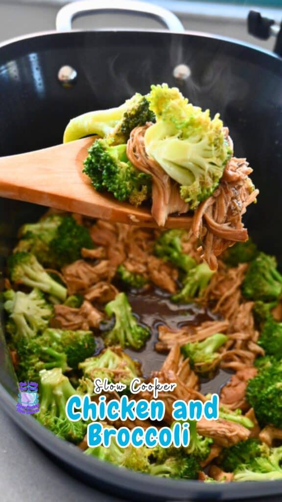 A wooden spoon lifts shredded chicken and broccoli from a steaming black slow cooker with savory sauce, showing a chicken and broccoli recipe