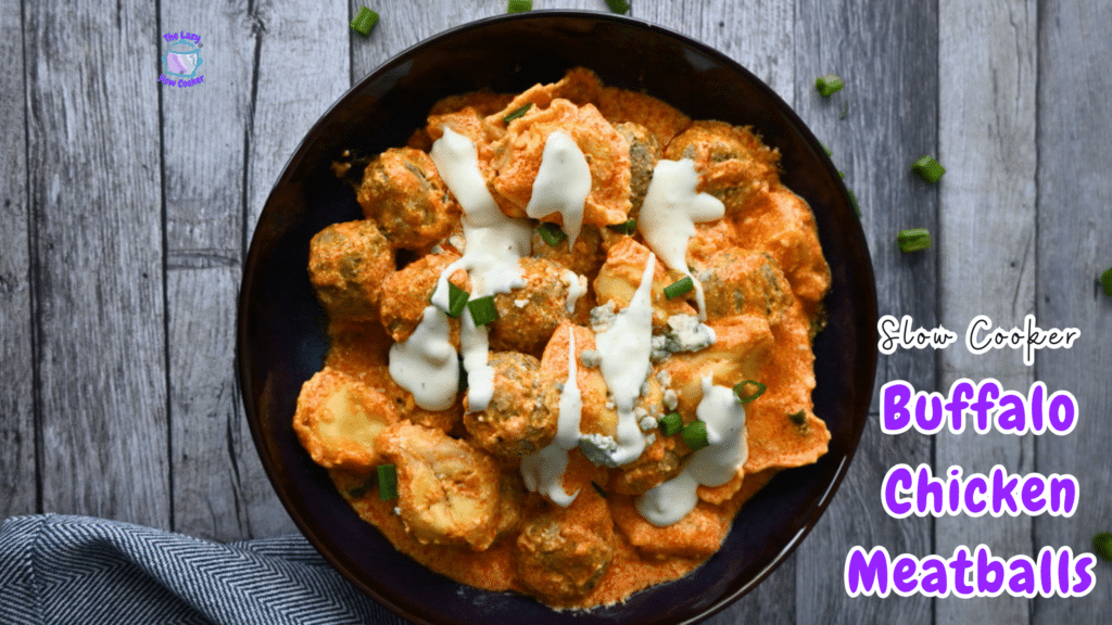 Buffalo chicken meatballs in orange sauce, topped with ranch and green onions, in a bowl on wood. Text: “Slow Cooker Buffalo Chicken Meatballs.”.