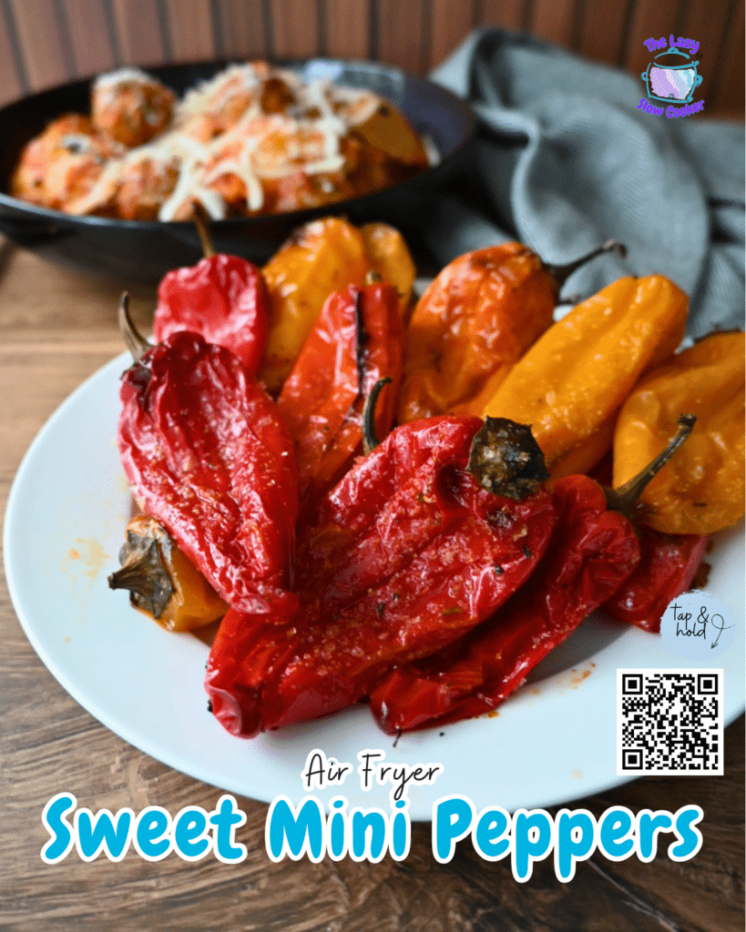 Roasted red and orange mini peppers on a white plate beside air-fried baby potatoes, with pasta in the background. Text: Air Fryer Sweet Mini Peppers, plus QR code and social icons.