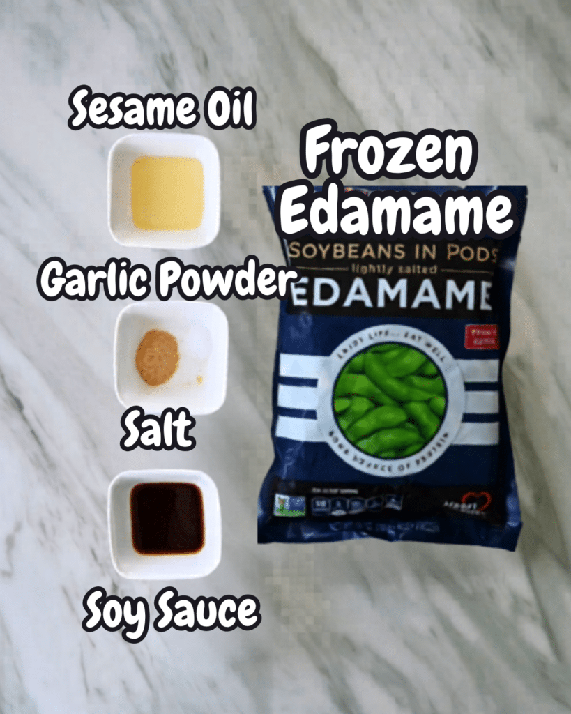 Four labeled ingredients for air fryer edamame-sesame oil, garlic powder, salt, soy sauce-and a bag of frozen edamame pods.