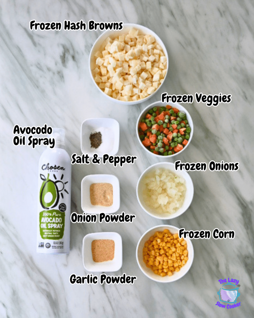 Overhead view of labeled bowls with frozen hash browns, veggies, onions, corn, spices, and avocado oil spray for air fried hash browns and vegetables
