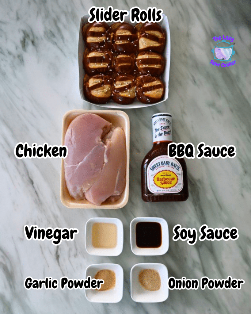 Ingredients for slow cooker BBQ chicken sliders laid out from above: slider rolls, raw chicken breasts, BBQ sauce bottle, and seasonings.