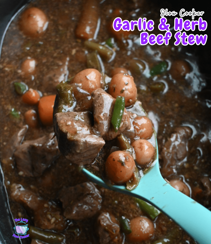 A teal spoon scoops beef, carrots, and green beans from rich stew in a slow cooker. Text says Slow Cooker Garlic Herb Beef Stew.