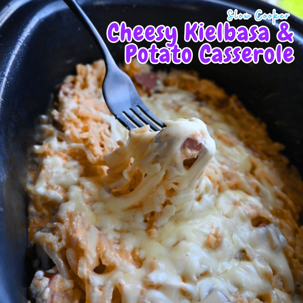 A fork lifts a gooey, cheesy bite from a slow cooker of kielbasa and potato casserole; recipe name appears in the top right.