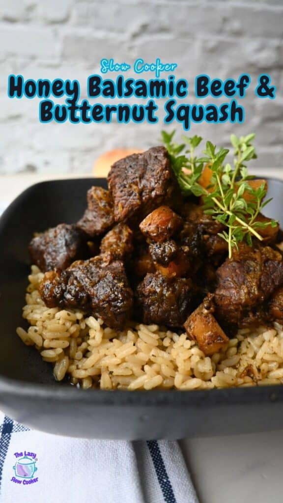A serving of honey balsamic beef and butternut squash is arranged over rice on a black plate, topped with fresh herbs. The image includes the text “Slow Cooker Honey Balsamic Beef & Butternut Squash” and a small logo in the lower left corner.